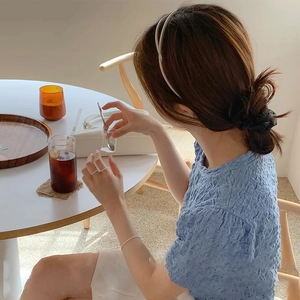 Light blue short sleeve top with pleated bubble fabric texture and minimalist style