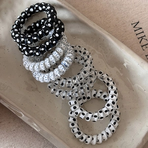 Elastici per capelli a spirale con motivi a pois nei colori nero, bianco e trasparente
