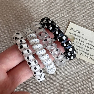 Set di 4 elastici per capelli a spirale con pois ad alta elasticità su sfondo strutturato