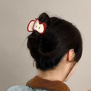 Creative red apple slice hair claw clip for women shown on model hair back view