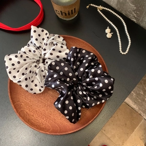 Polka dot satin scrunchie set in black and white displayed in a premium wooden tray