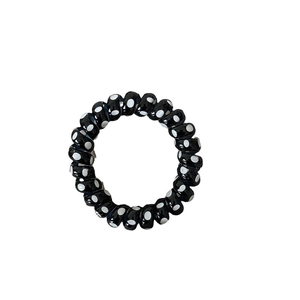 Elastico per capelli a spirale nero con pois bianchi, resistente e delicato sui capelli