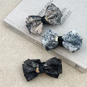 Three-piece set of ink painting style bow hair clips with elegant gold metal tags