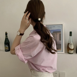 Pink striped cotton shirt styled with a black pearl hair tie and silver twisted ring