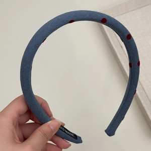 Detail of blue polka dot headband showing high-quality fabric and hand made label