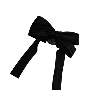 Elegant black satin ribbon bow hair claw clip for a French minimalist hairstyle