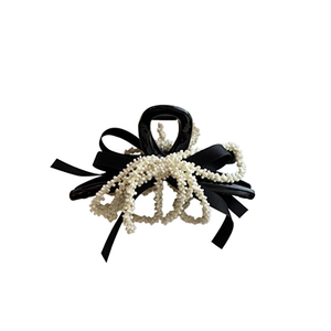 Elegant French style hair claw clip with black bow, white pearls and tassels on white background