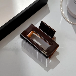 Close-up of rectangular tortoise acetate hair claw with France Handmade gold lettering