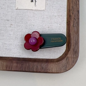 Detailed macro view of the France Handmade inscription on a floral acetate hair clip