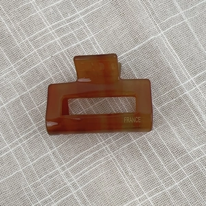 Detailed close-up of amber tortoiseshell claw clip with FRANCE Handmade gold lettering