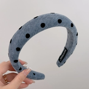 Detailed view of blue denim polka dot padded headband with Hand Made inner label