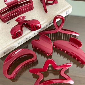 7-piece set of burgundy geometric hair clips including star, heart and crescent moon shapes