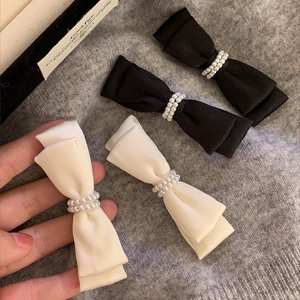 Elegant satin bow hair clips with double-row pearls in black and cream white colors