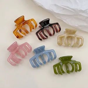 Set of six jelly color acetate hair claws in various finishes like amber and cream