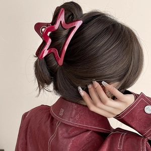 Elegant burgundy star-shaped hair claw clip for women shown on a model hairstyle