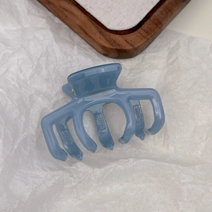Detailed view of light blue jelly acrylic hair claw clip with France embossing and metal spring