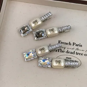 Set of four elegant silver hair clips with bow details and sparkling zircon crystals