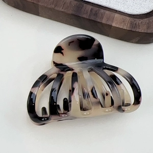 Detail view of medium French acetate hair claw clip with vintage tortoiseshell texture