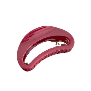 Minimalist burgundy hair claw clip with crescent hollow design on white background