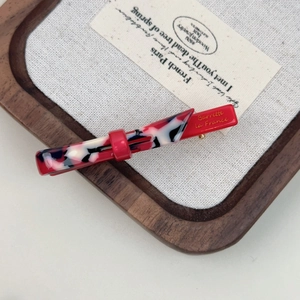 Elegant marble pattern hair clip with red base and gold Barrette La France lettering