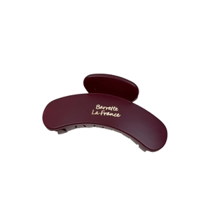 French style wine red large hair claw clip with golden lettering on white background