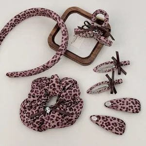 Pink leopard print hair accessories set featuring bow clips and claw clips for women