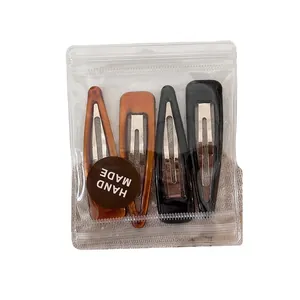 Lot de 4 barrettes minimalistes gouttes d'eau en ambre et noir sur fond de toile