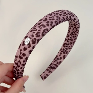 Elegant purple leopard print fabric headband with silver metallic logo plaque decoration