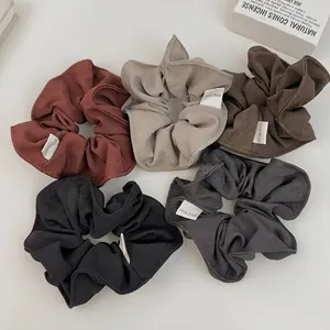 Five-piece set of handmade fabric scrunchies in minimalist earth tones for women
