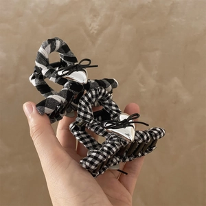 Checkered black and white fabric shark hair clips with silver heart and bow details