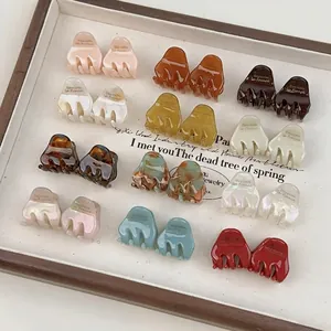 French style acetate hair claw clips in various colors displayed on a boutique tray