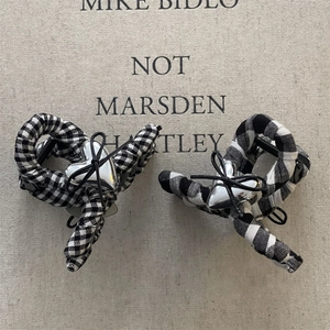 Set of 2 black and white checkered hair clips with silver heart and bow detail