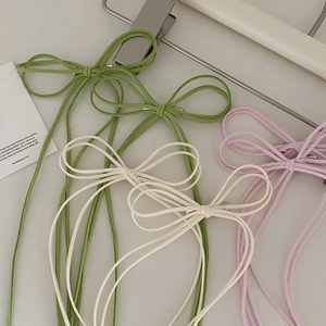 Three minimalist suede bow hair clips in green, white and pink for elegant hairstyles