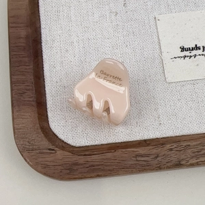 Detailed macro view of a pink acetate hair claw clip with Barrette La France lettering