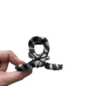 Classic black and white checkered shark hair clip with silver heart and bow detail