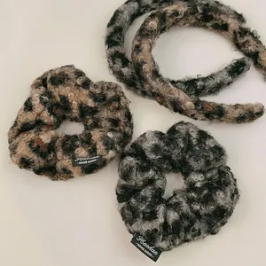 Leopard print plush hair scrunchies set with a faux lamb wool texture and brand label