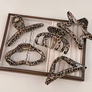 Set of five vintage leopard print hair claws in various shapes for thick hair styling