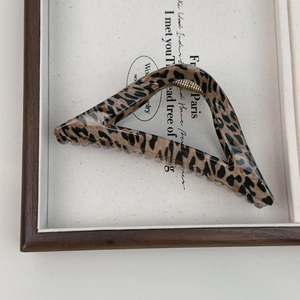 Detail shot of leopard print large hair claw clip with golden metal spring mechanism