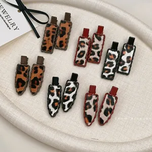 Set of 6 leopard print hair clips in rectangle and teardrop shapes with metal base