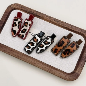 Set of three leopard print hair clips in gold alloy with velvet texture for women