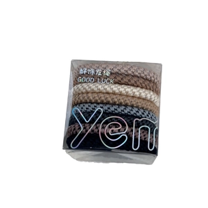 Elastic braided hair ties set in earth tones including black and grey in a storage box