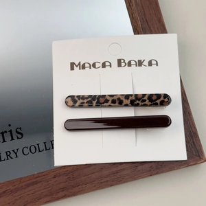 Close-up of leopard print and dark brown hair clips set on a display card
