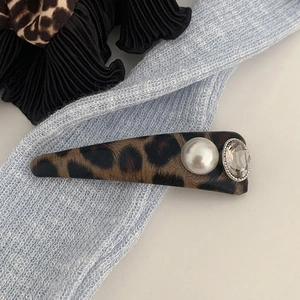 Elegant leopard print hair clip with plush fabric, white pearl, and large clear crystal