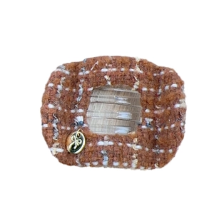 Brown and white tweed hair claw clip with golden bow tag and star charm details