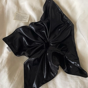 Glossy black pleated oversized scrunchie hair tie with elegant satin leather texture