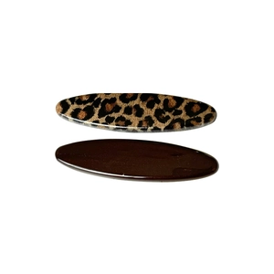 Set of two leopard print and dark brown oval hair clips with glossy finish on white base
