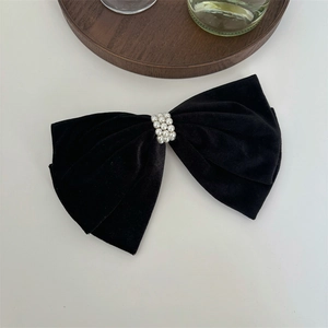 Elegant black velvet bow hair clip with luxury pearl accent in a French vintage style