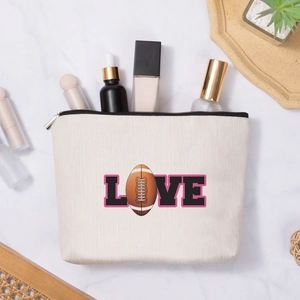 Linen texture makeup bag with football LOVE print and zipper closure on marble background