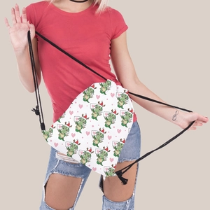 Detail showing Christmas green dinosaur print and durable black drawstrings on travel bag