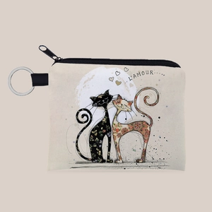 Close-up of canvas coin purse with artistic cat print and metal keychain ring detail